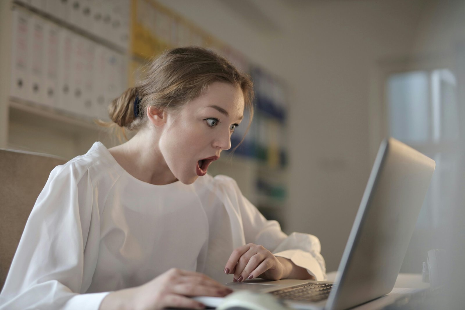5 Woman with surprised expression at laptop